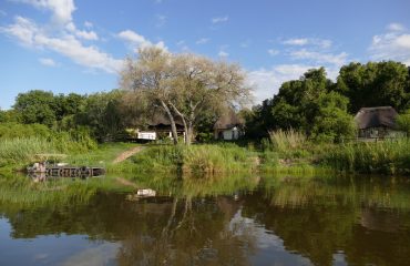 LODGE FROM RIVER WITH SWALLOW